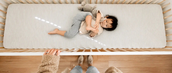 An image of a baby lying in a crib