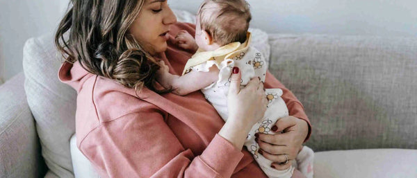 A mother putting a crying baby to rest