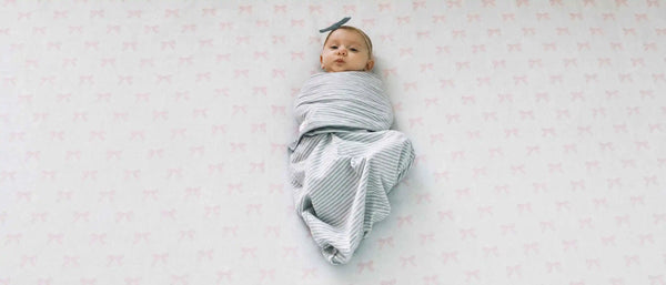 An image of a swaddled baby