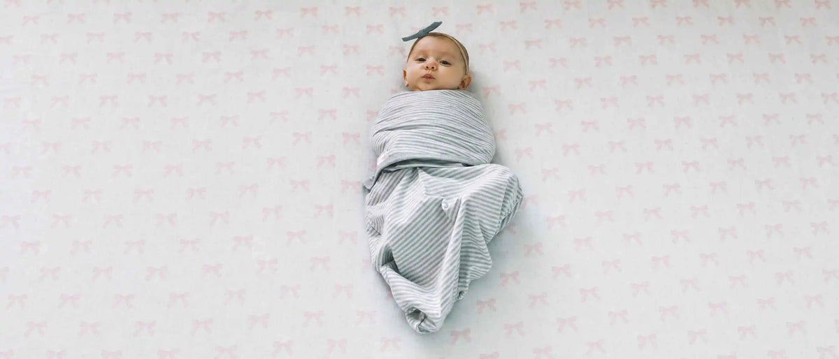 An image of a swaddled baby