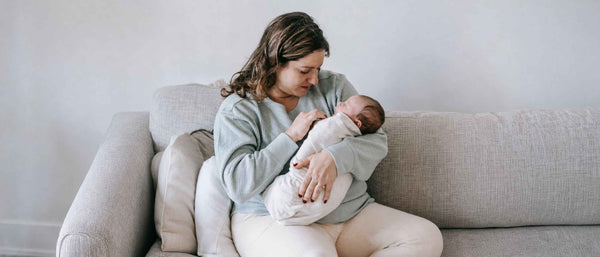A mother rocking the baby to sleep