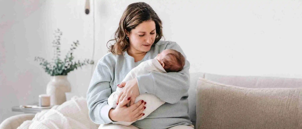 An image of a new mom holding her baby