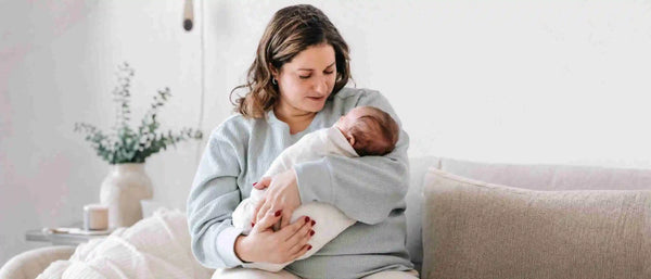 An image of a new mom holding her baby
