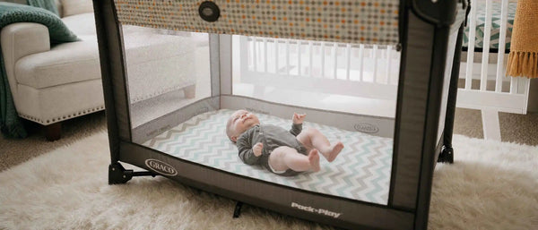 An image of a baby playing in a pack n play