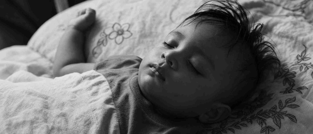 A baby sleeping in the dark