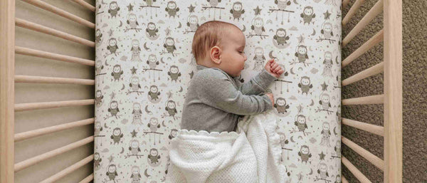 A baby sleeping in a crib