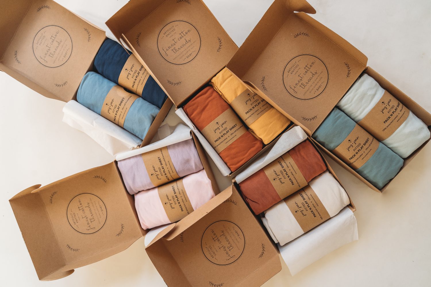 Joey + Joan sheets in open recyclable kraft gift boxes