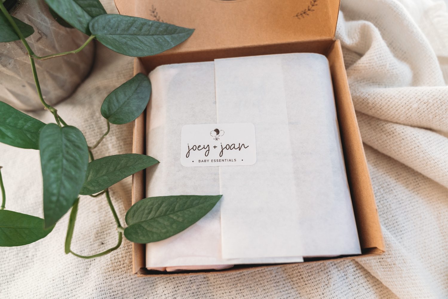 A Joey + Joan sheet wrapped in recyclable kraft packaging