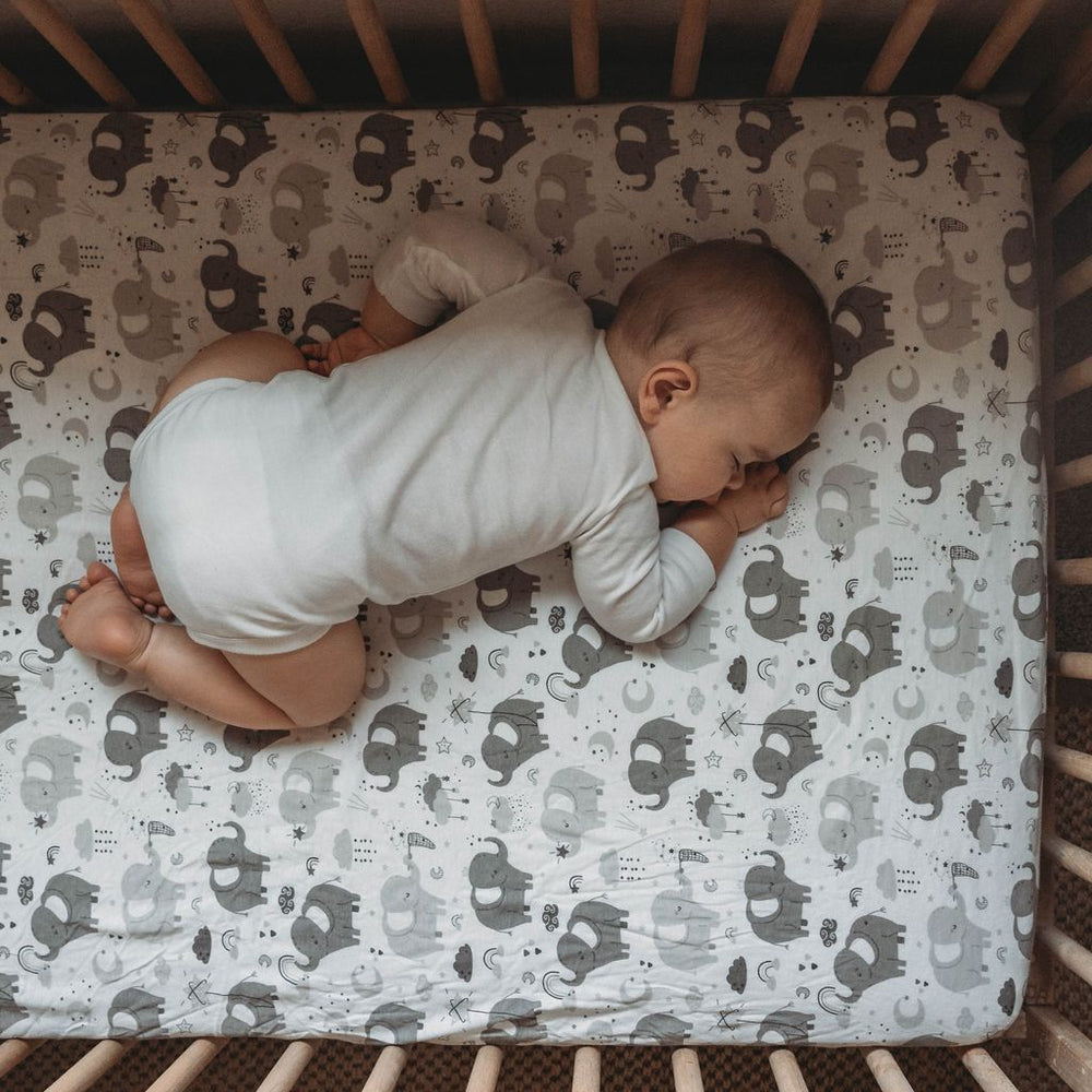 Joey + Joan jersey knit cotton fitted sheet in a crib