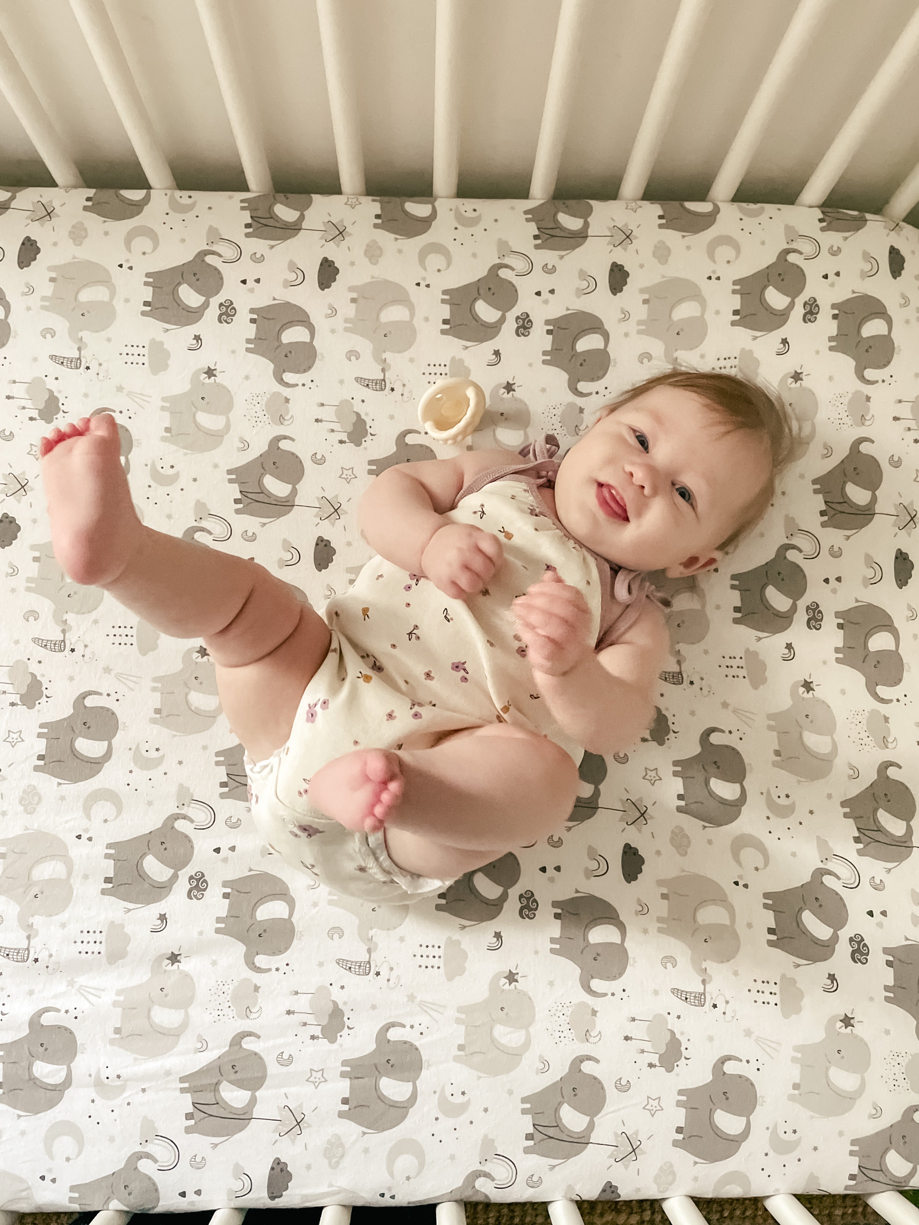 Joey + Joan sage pack-n-play sheets in a woven basket