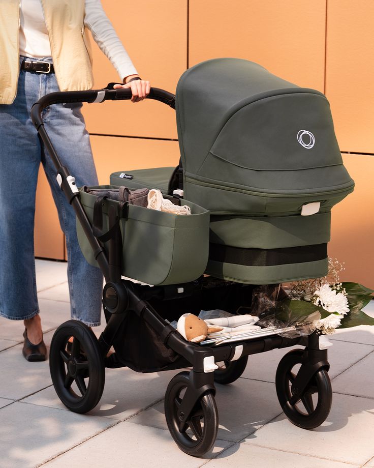 Parent pushing a Bugaboo Donkey with the bassinet attached